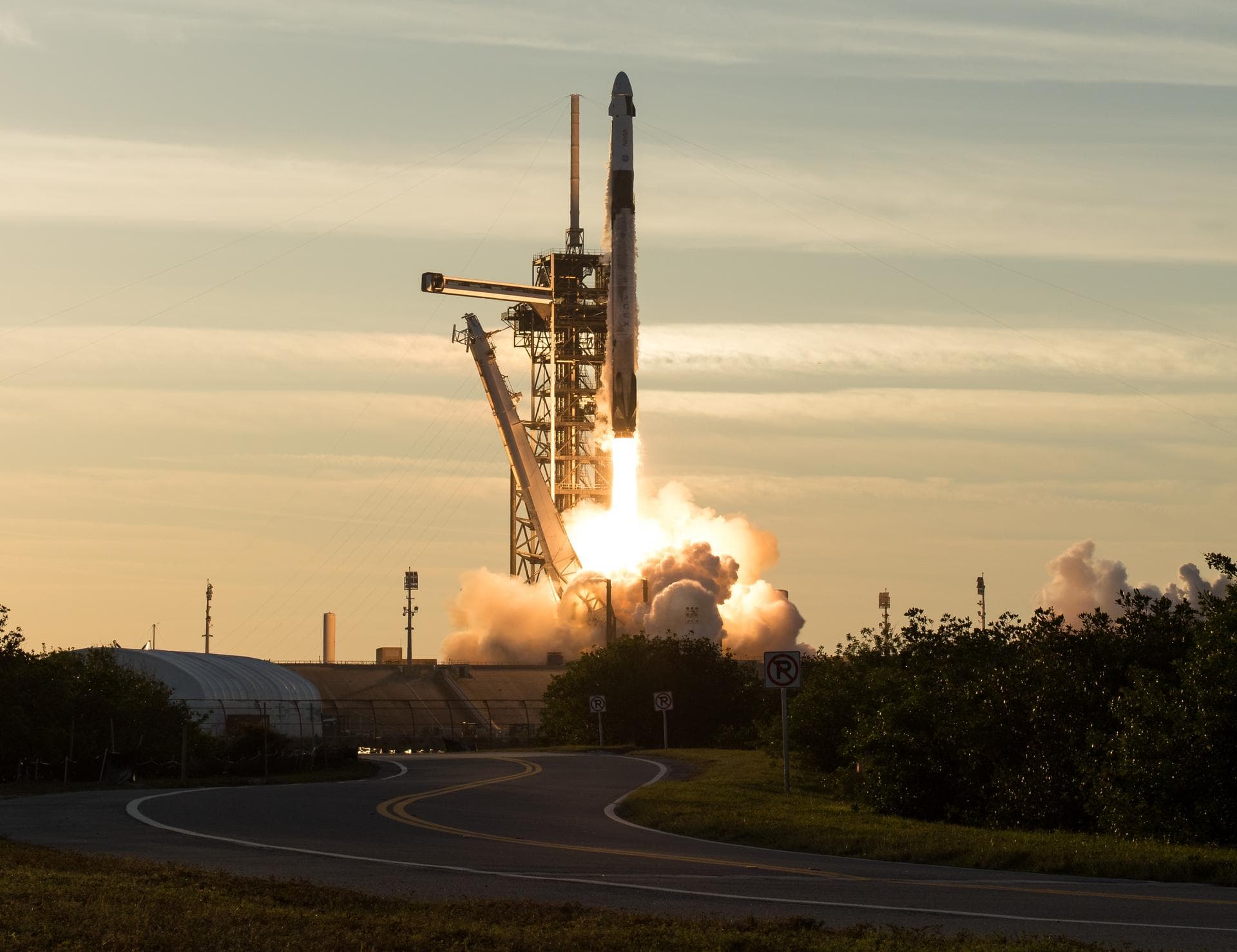 A SpaceX Falcon 9 launching a NASA crew mission at sunrise