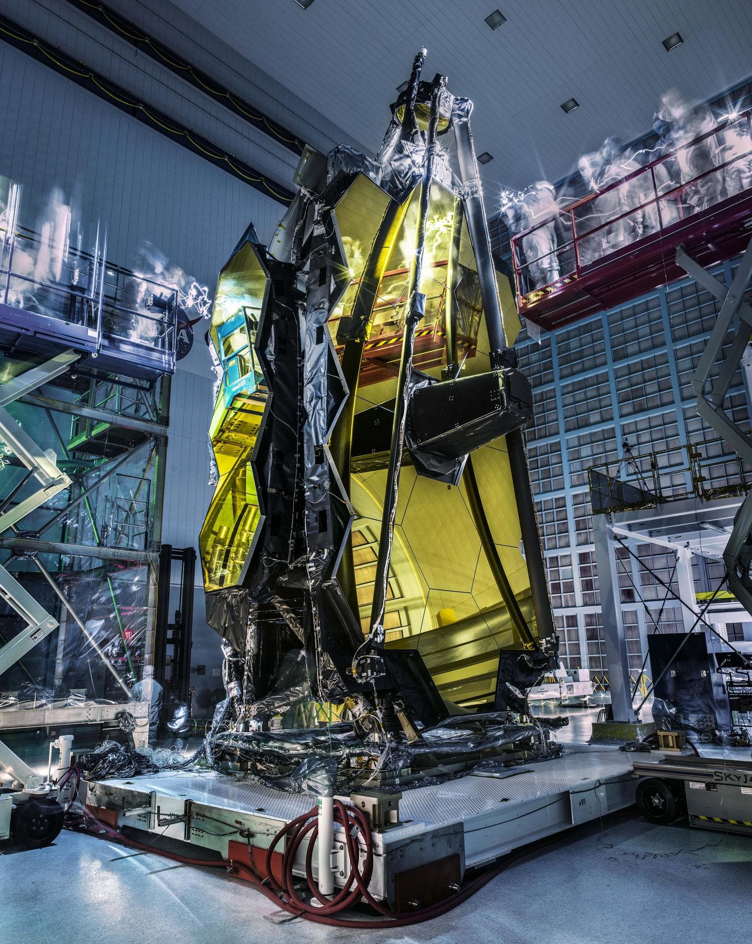 The folded James Webb Space Telescope standing inside NASA's clean room